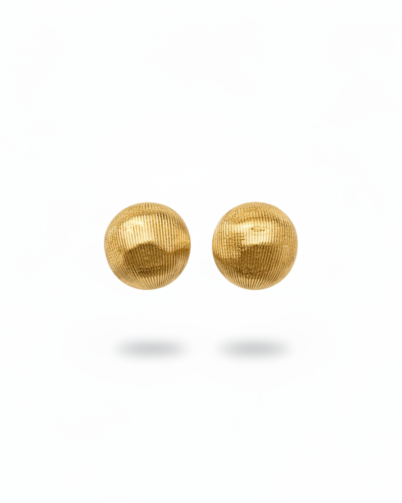 Pair of gold mesh sphere earrings with vertical lines on a white background